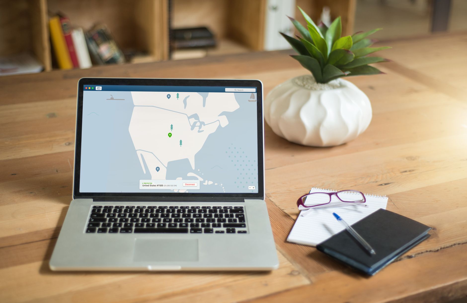Small business owner reviewing insurance paperwork beside a laptop, cyber insurance context
