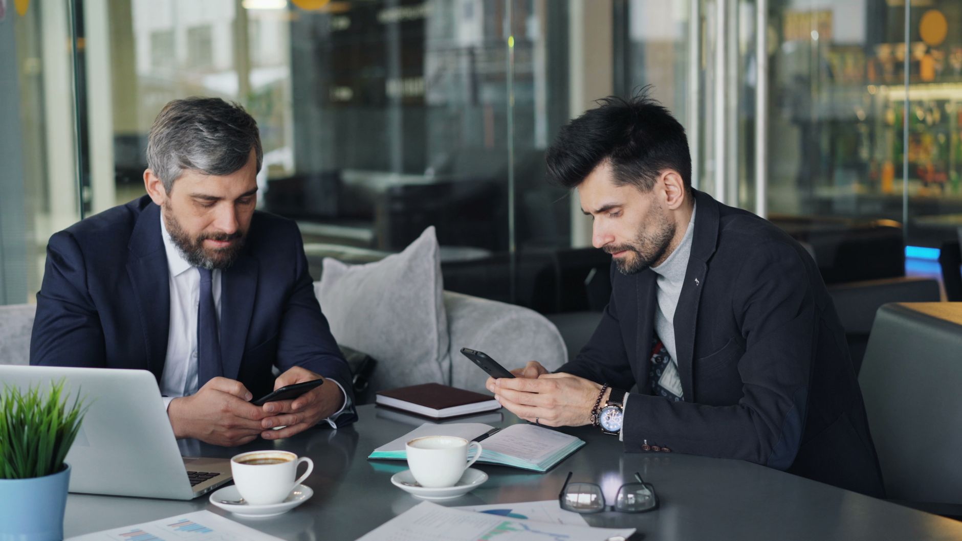 Malta business team reviewing mobile plan costs on laptops and phones