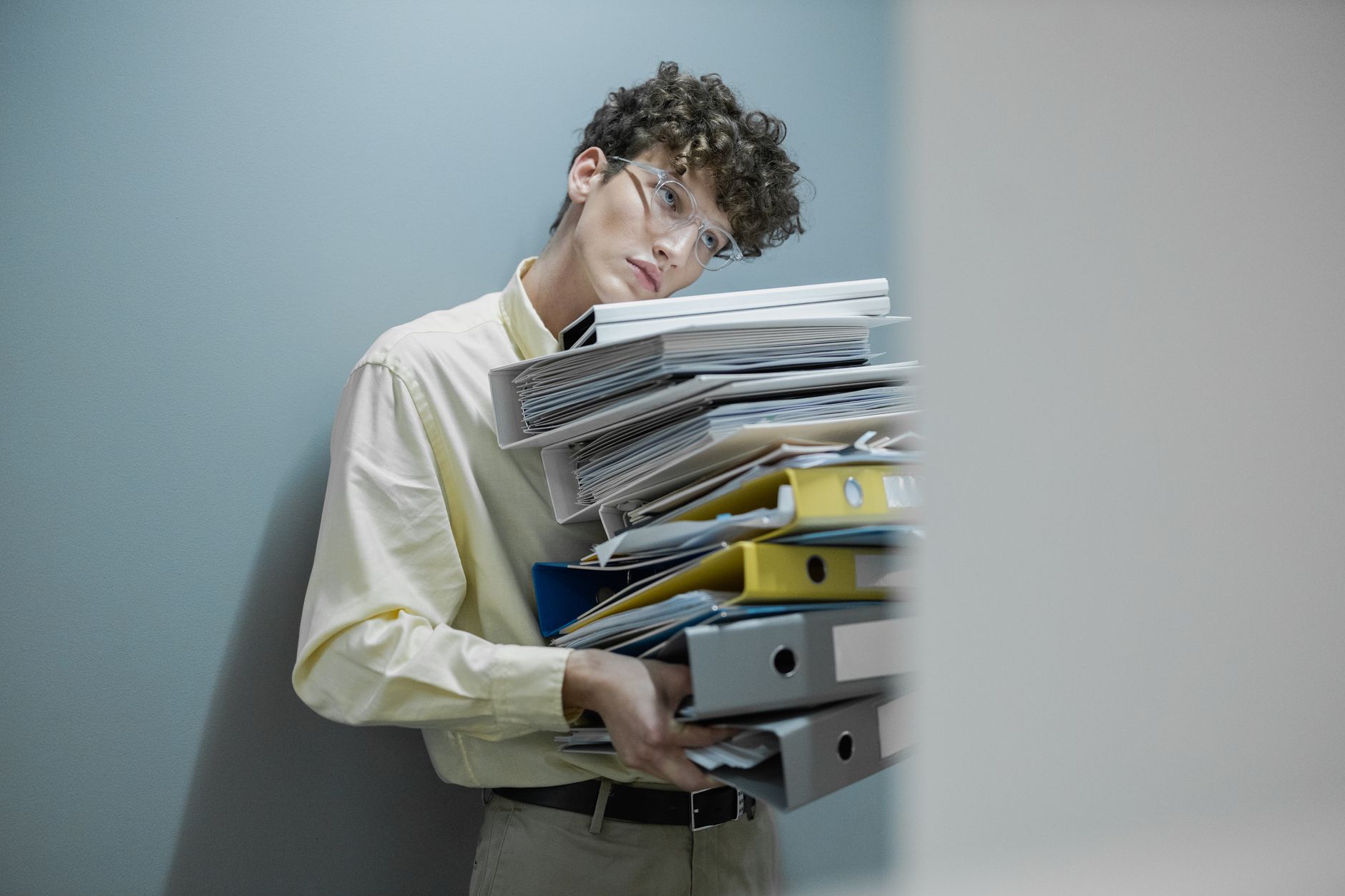 Overworked single IT person managing multiple screens in a small business office